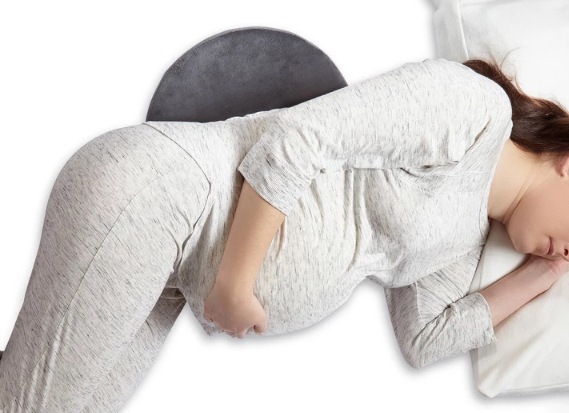 Pregnant Women with White Clothes, Using Hiccapop Pregnancy Pillow in His Back