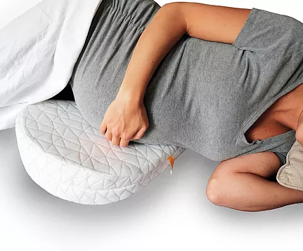 A Pregnant women slpeeing with Jill and Joey Pregnancy Pillow