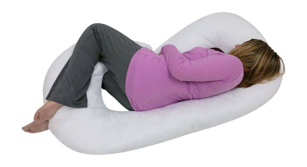 A Pregnant Woman is sleeping with J-Shaped Pregnancy Pillow