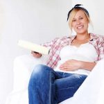 A Pregnant Woman Sitting in Newly Painted Room