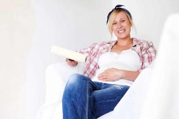 A Pregnant Woman Sitting in Newly Painted Room