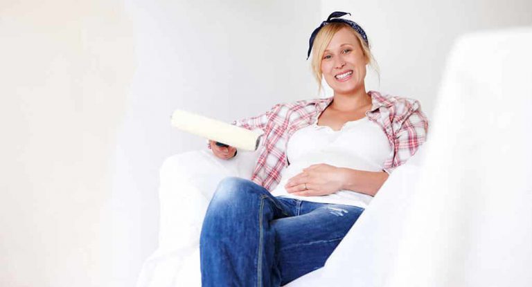A Pregnant Woman Sitting in Newly Painted Room