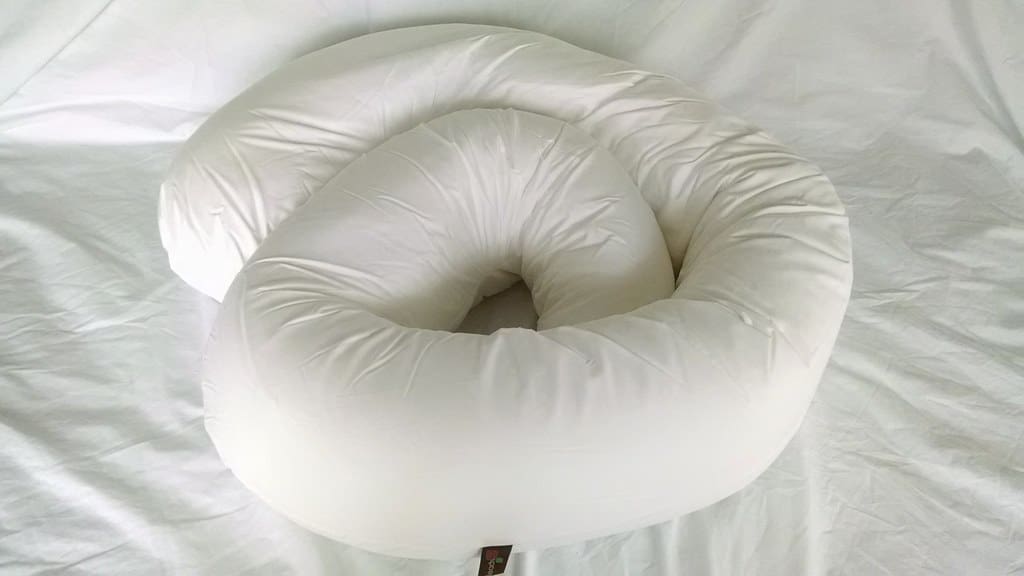 A Clean white Pregnany Pillow on Bed