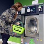 A Woman Washing the Pillow with Machine Machine