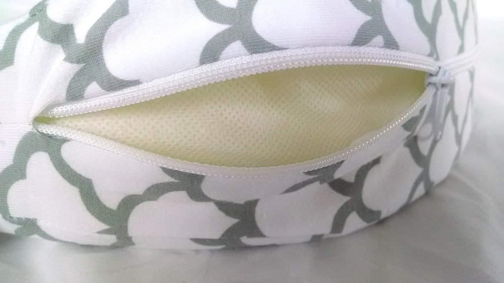 A pregnancy pillow with open zip